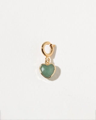 Gold heart-shaped pendant with a green gemstone on a white background