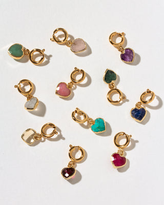 A set of gold heart-shaped charm clips with various colored stone hearts, arranged on a clean white background.