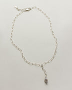 Silver chain necklace with herkimer quartz pendant on a white background.