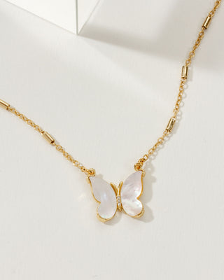 Gold necklace with a butterfly pendant on a white background