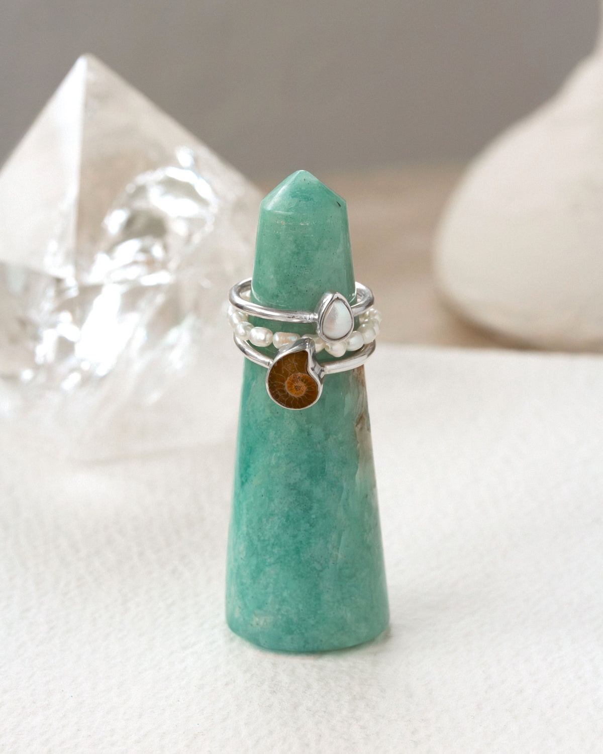 Amazonite ring tower with silver ammonite and pearl rings, plus a pearl stretch ring