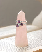 Three silver rings with purple amethyst gemstones