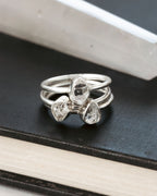 Three stacking silver rings, one on top of each other, with teardrop-shaped Herkimer quartz gems