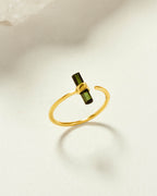 Gold ring with a vertically set green watermelon tourmaline gemstone on a gold-plated silver band.