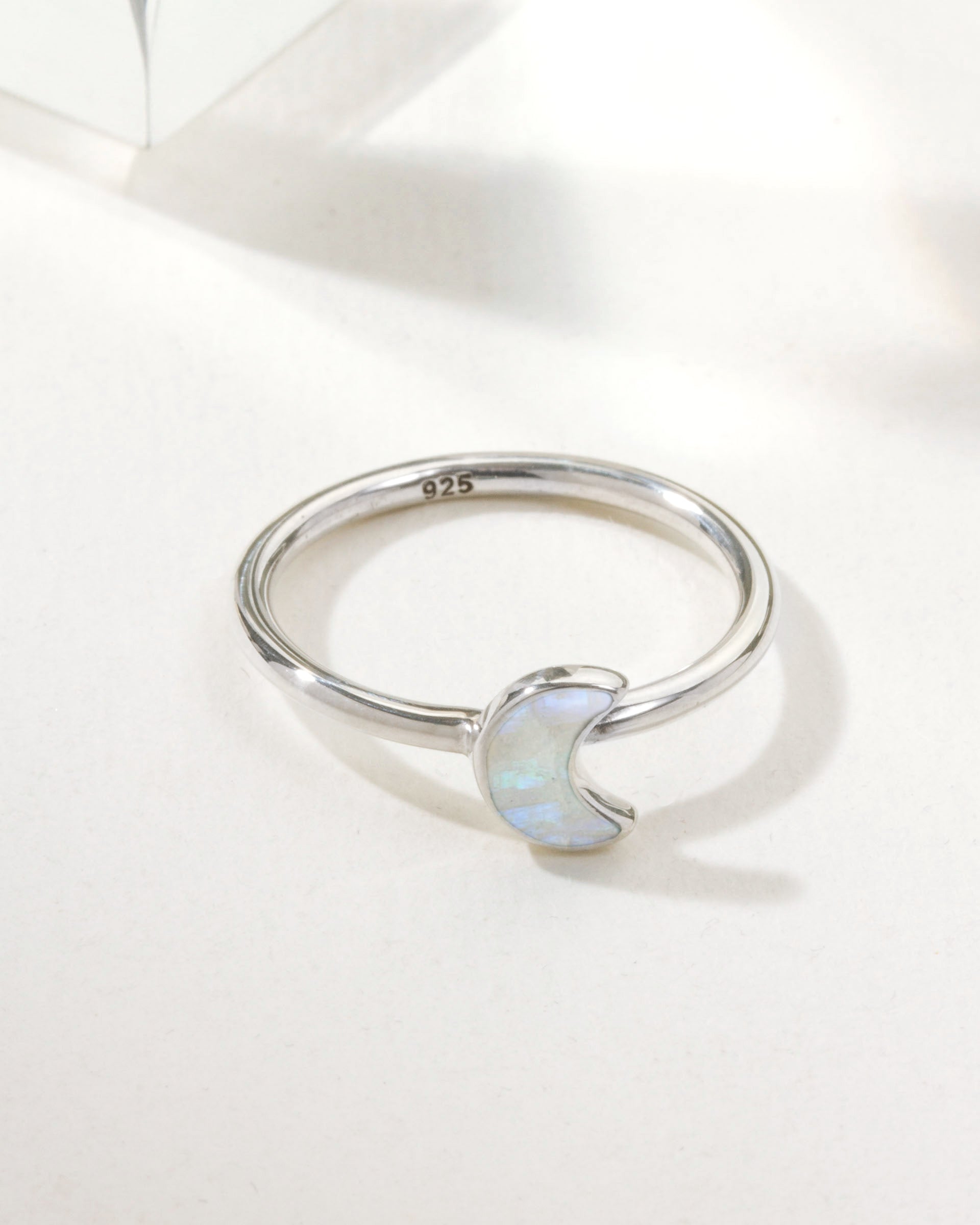 Sterling silver ring featuring a moonstone crescent accent.