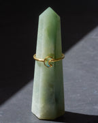 Gold ring with a moon design on a green crystal