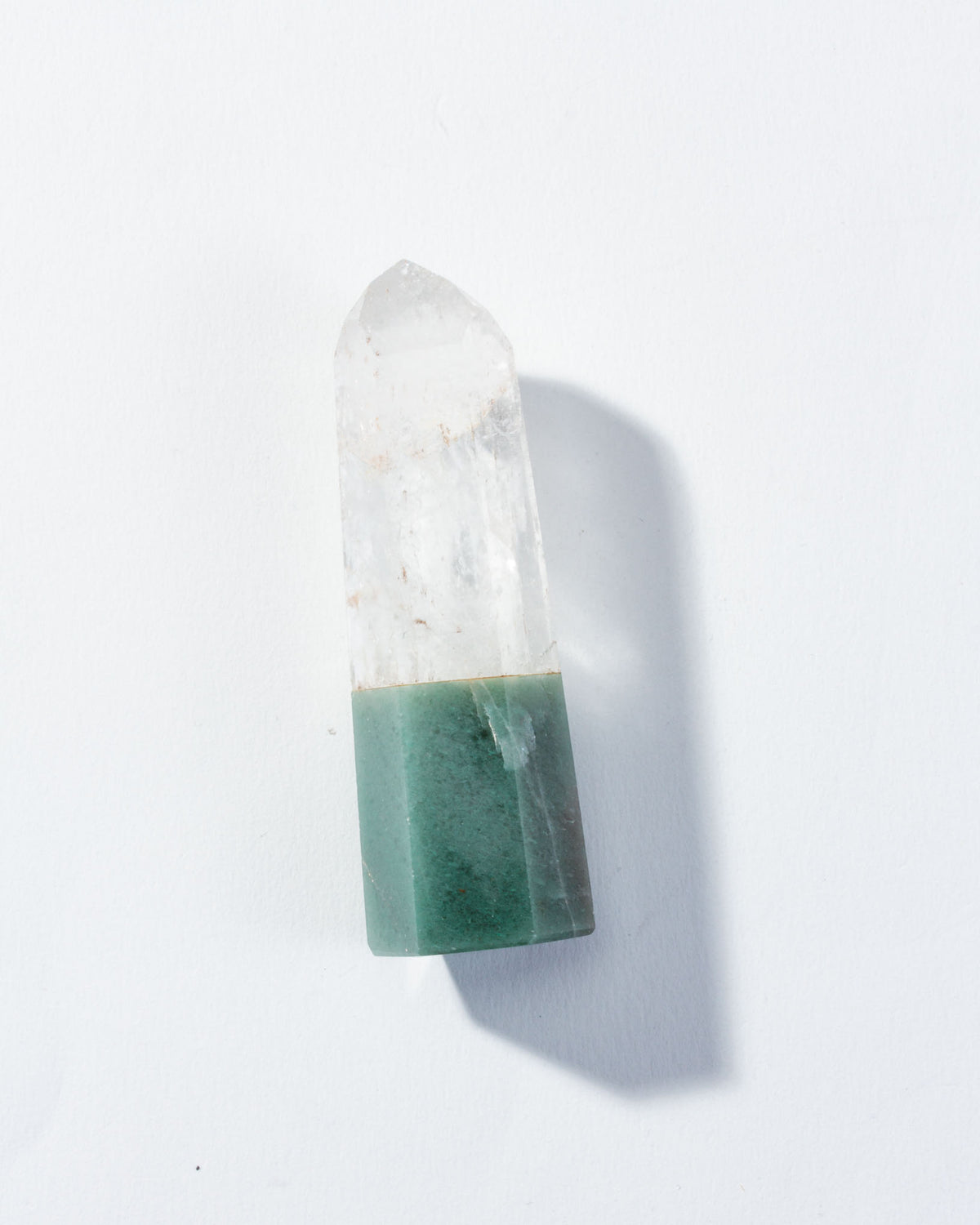 Crystal with green base on a white background