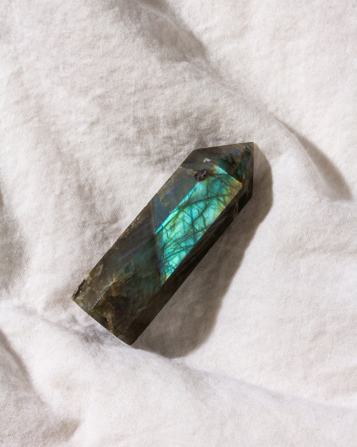 Labradorite crystal on a white fabric background