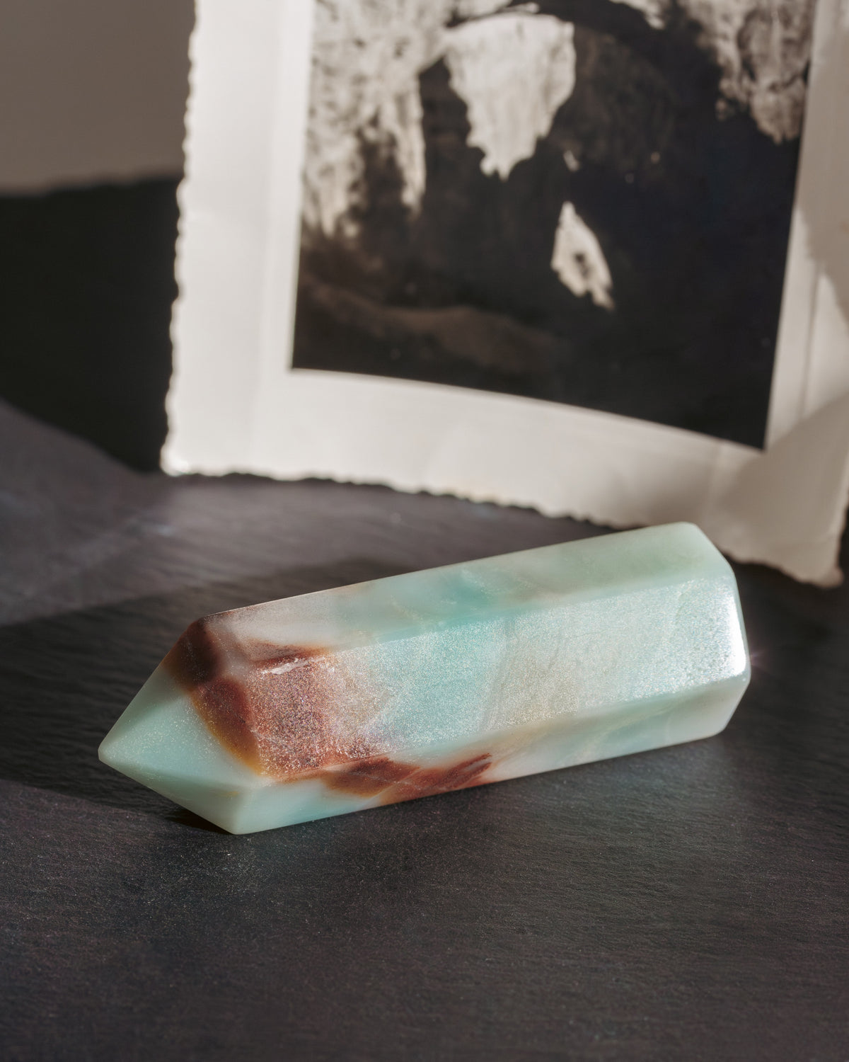 Polished quartzite mint colored stone on a dark surface