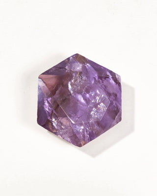 Hexagonal purple crystal on a white background