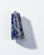 Tall, multi-colored crystal on a white background