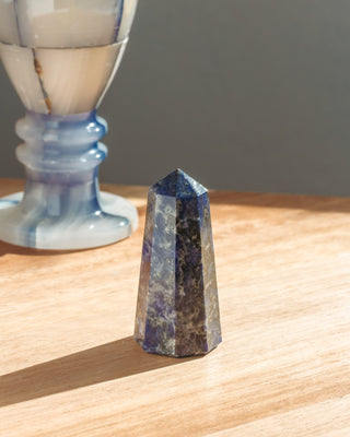 Crystal pyramid on a wooden surface