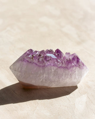 Amethyst crystal on a light beige background