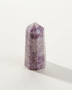 Purple Lepidolite Gemstone Tower on a white background.