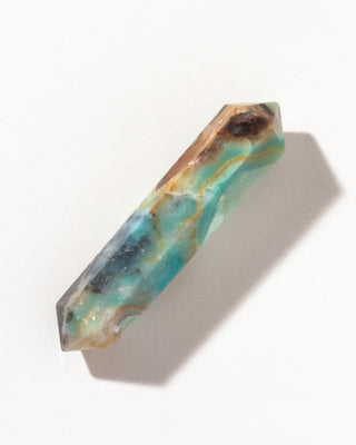 Decorative Quartzite double point wand crystal with green-blue and golden brown patterns on a white background