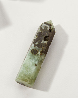 Flat bottom Prehnite crystal tower laid flat on white background