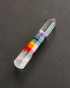 Crystal with color bands on a dark gray background