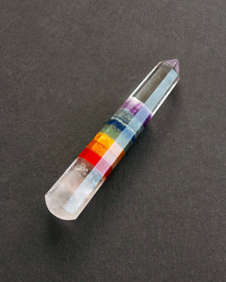Crystal with color bands on a dark gray background