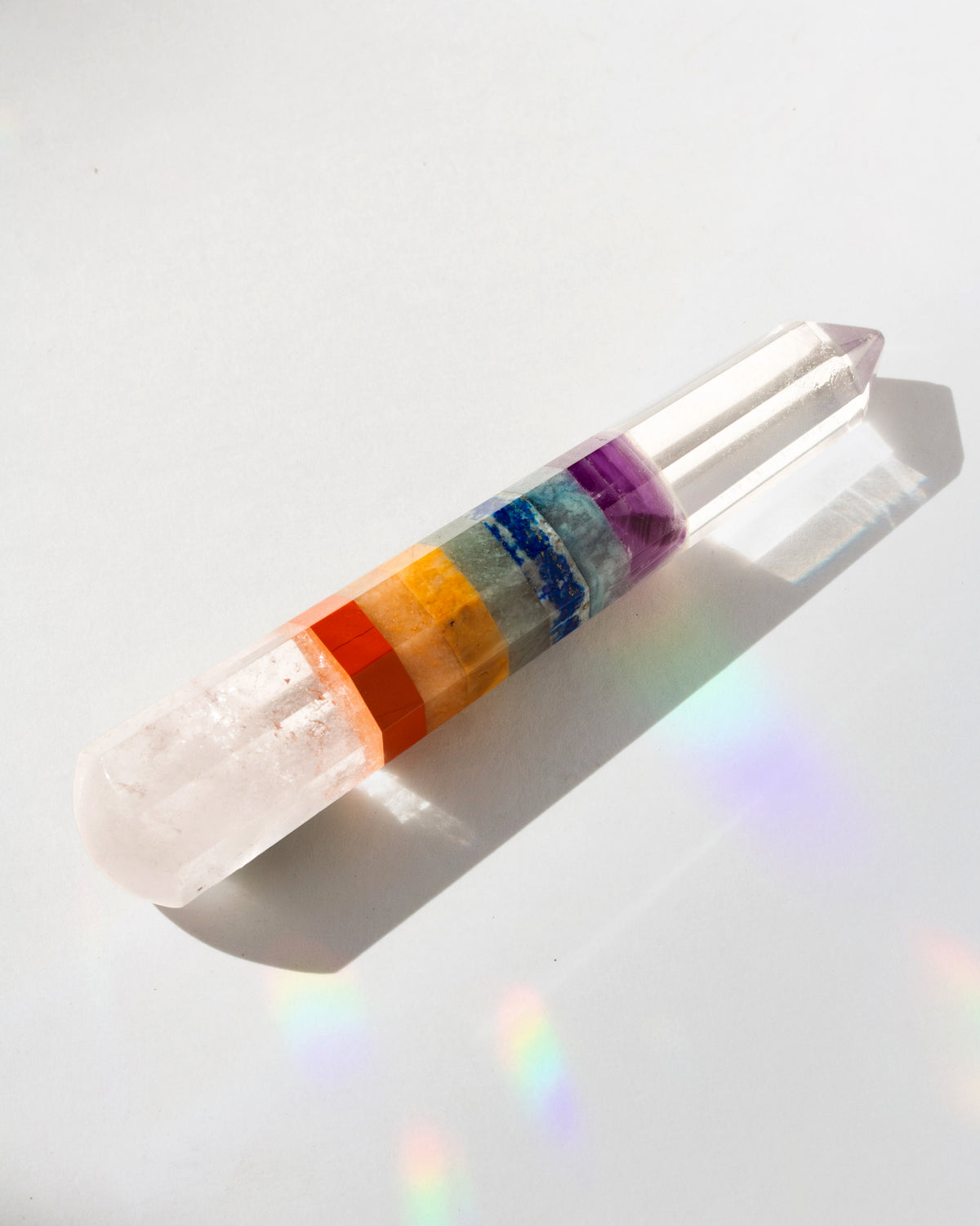 Crystal wand with color bands on a white background