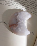 Decorative stone with a semi-circular shape on an open book