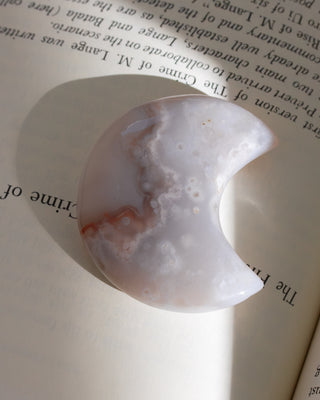 Decorative stone with a semi-circular shape on an open book
