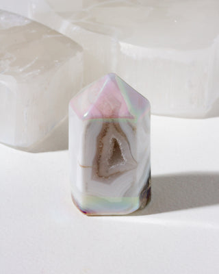 Geometric crystal with a natural geode interior on a white background