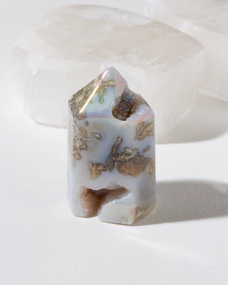 Decorative stone with gold and silver metallic inclusions on a white background