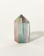 Aura Quartz Tower with a blue iridescent coating displaying a shimmering, multi-colored sheen.