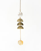 Pearl Mirage Mobile featuring a pearlescent disc, golden rings, faceted citrine crystal and gold chain.