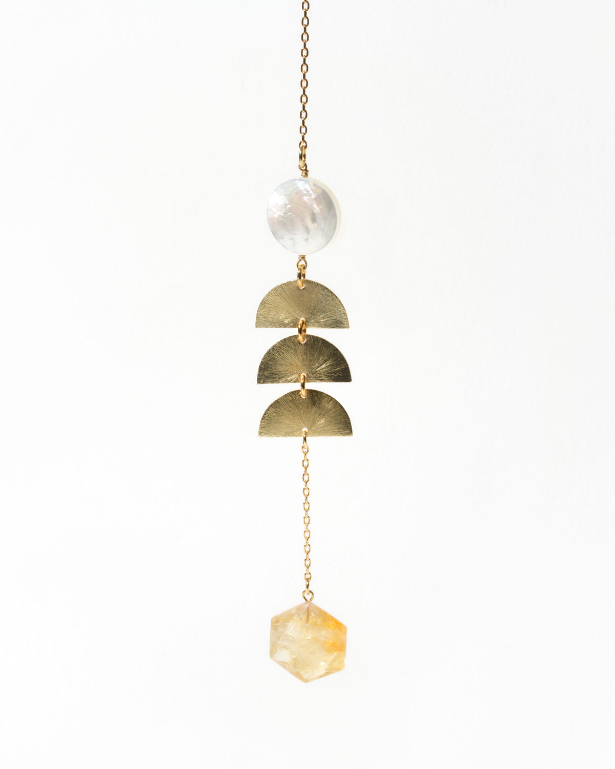Pearl Mirage Mobile featuring a pearlescent disc, golden rings, faceted citrine crystal and gold chain.