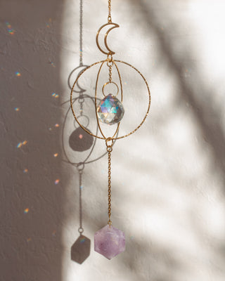Decorative hanging crystal with geometric shapes on a neutral background