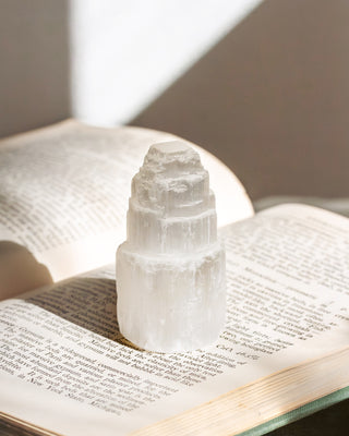 Crystal on an open book with a soft light background