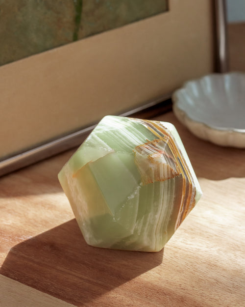 Faceted crystal on a wooden surface with a blurred background