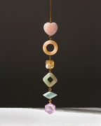 Decorative hanging with colorful beads on a dark background