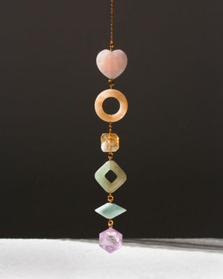 Decorative hanging with colorful beads on a dark background