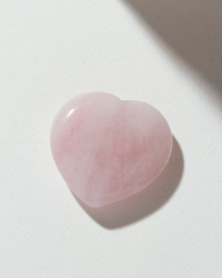 Rose quartz heart curio on a white background.