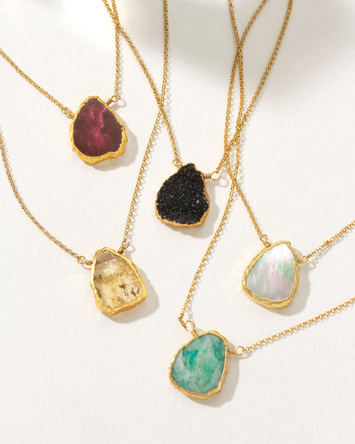 Five Earth, Wind and Fire necklaces with ruby, druzy quartz, citrine, pearl, and amazonite