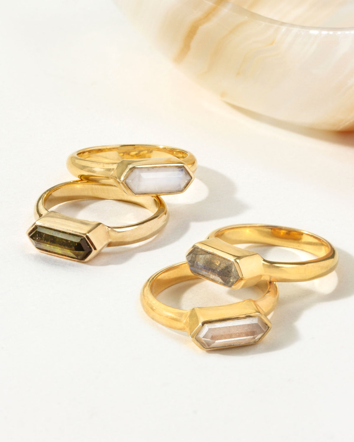 Gold Kaleidoscope rings with Green Tourmaline, Moonstone, Labradorite, and Clear Quartz gems.
