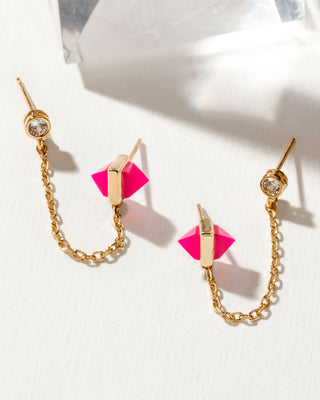Gold crystal stud chain earrings with pink dual-sided pyramid onyx gemstones on a white background