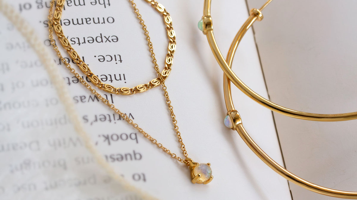 Gold necklace and bracelet on a book page
