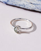 A silver ring featuring a crescent moon-shaped inlay labradorite genuine stone.