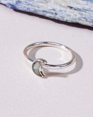 A silver ring featuring a crescent moon-shaped inlay labradorite genuine stone.