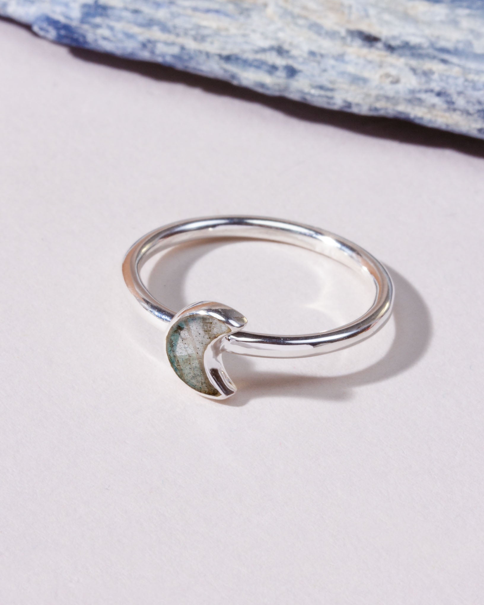 A silver ring featuring a crescent moon-shaped inlay labradorite genuine stone.