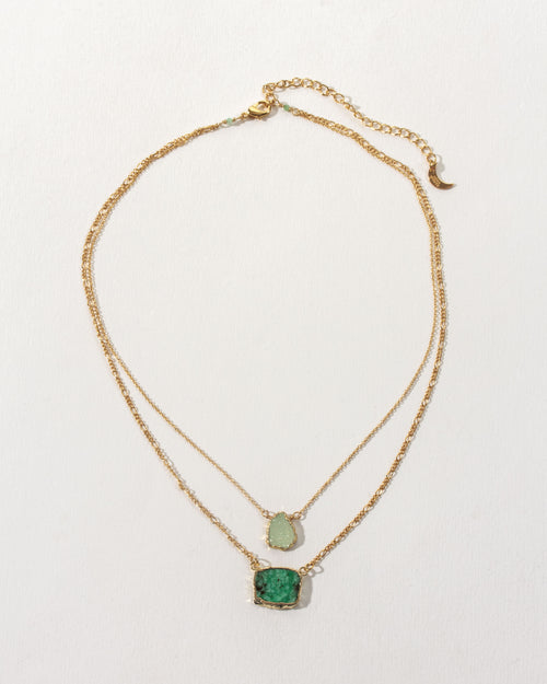Emerald Sea Layered Necklace featuring green gemstones on a gold chain.