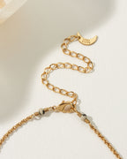 Close-up of the Spot On Medallion Necklace's gold chain, clasp, extender, and branded moon charm.