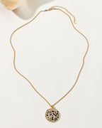 Spot On Medallion Necklace with a round Dalmatian stone pendant and gold chain.