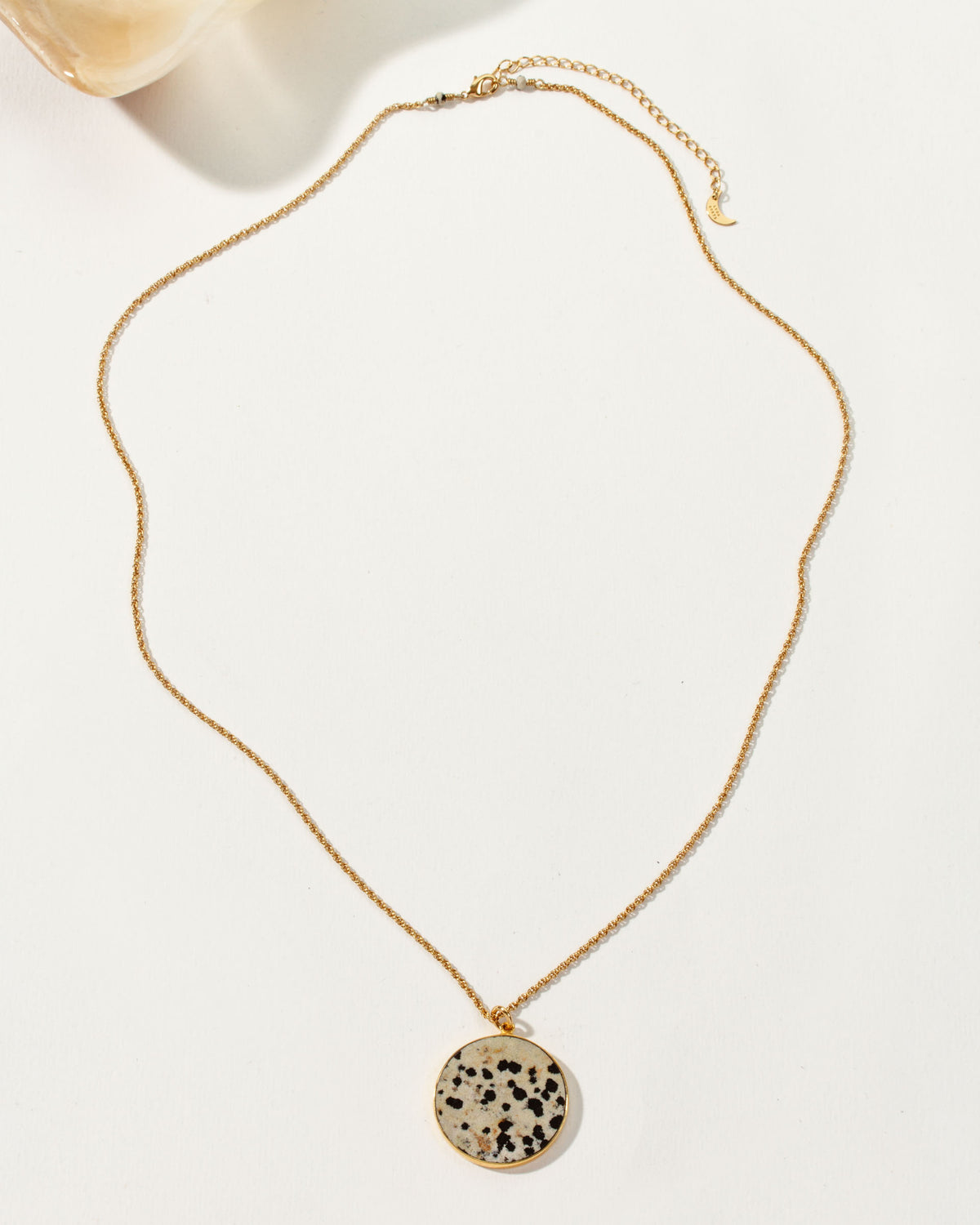 Spot On Medallion Necklace with a round Dalmatian stone pendant and gold chain.