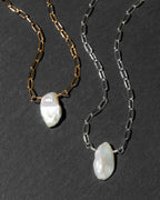 Two paperclip chain necklaces with  white Keshi pearls, one in gold-tone metal and one in silver-tone metal.