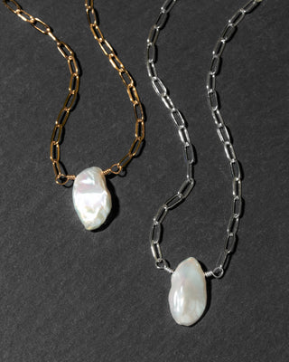 Two paperclip chain necklaces with  white Keshi pearls, one in gold-tone metal and one in silver-tone metal.