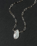 A silver paperclip chain necklace with  irregular Keshi pearl pendant.